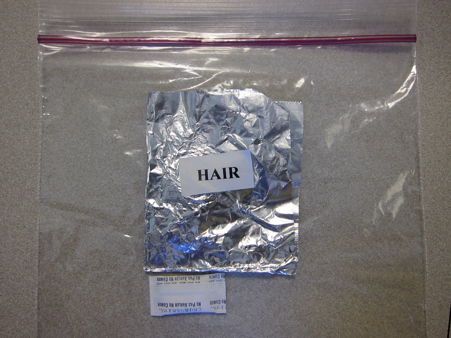 a hair sample wrapped in foil and then sealed inside a zip lock plastic bag